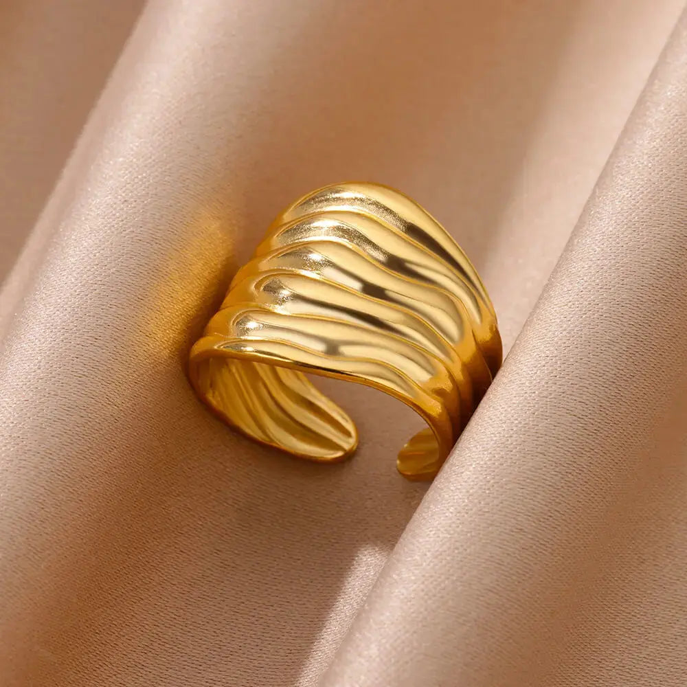 Irregular geometric gold ring with a chunky adjustable design for women, showcasing a modern wave pattern.