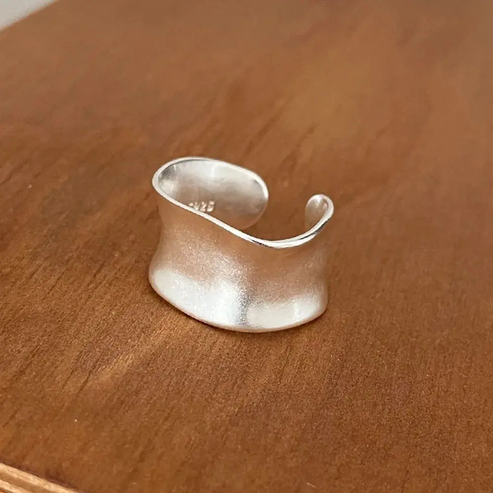 Open Vintage Sterling Silver Ring – Timeless Adjustable Cocktail Band displayed on wooden surface.