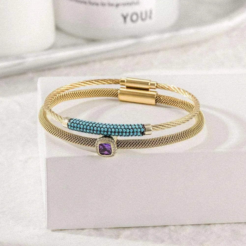 Vintage stainless steel jewelry set with gold-toned bracelets featuring turquoise and purple stone accents